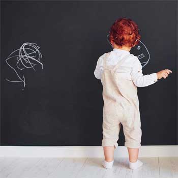 Child Drawing on Chalkboard Wall Decal